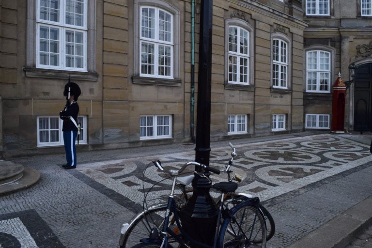 Danish bikes and guard with fuzzy hat.
